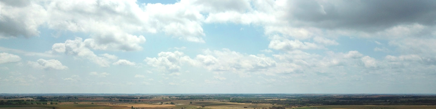 Panoramic view of agricultural lands with a clear sky